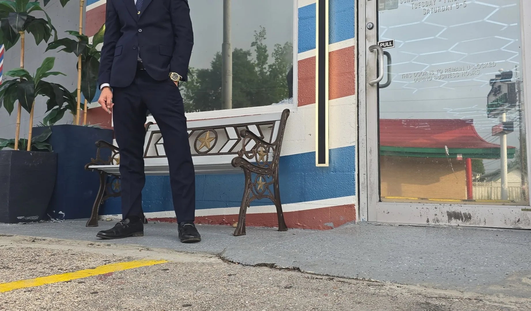 The front of Jeremy's Barber Shop on 1st St, barber pole by the door